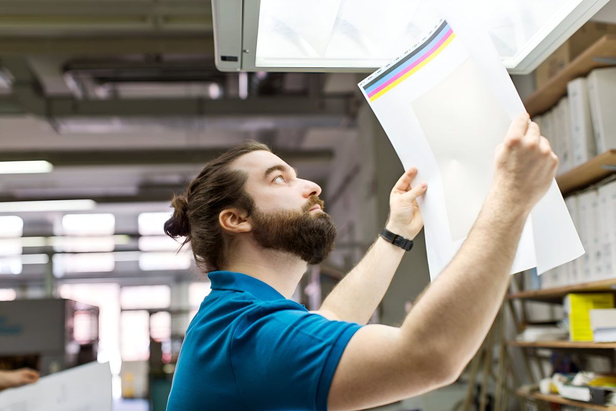 worker-checking-colour-proofs-printing-min